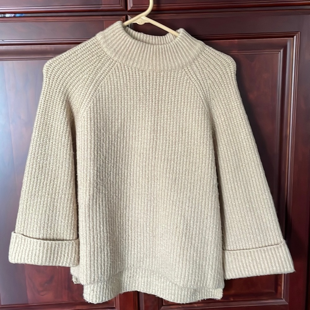 Barely worn tan sweater. Bell sleeves.